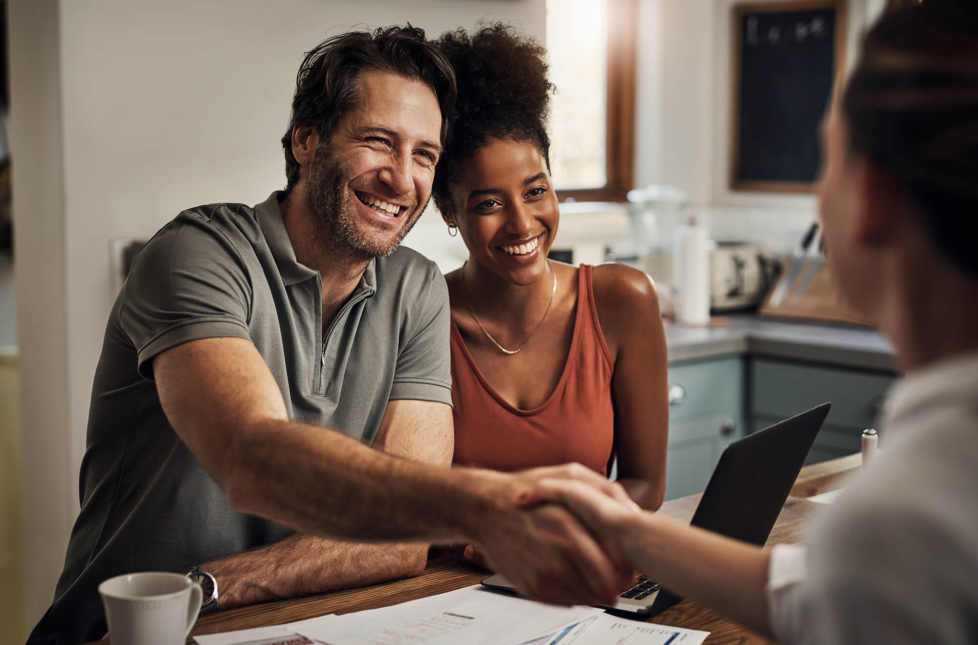 Middle aged man shaking hands with a financial advisor during a consultation